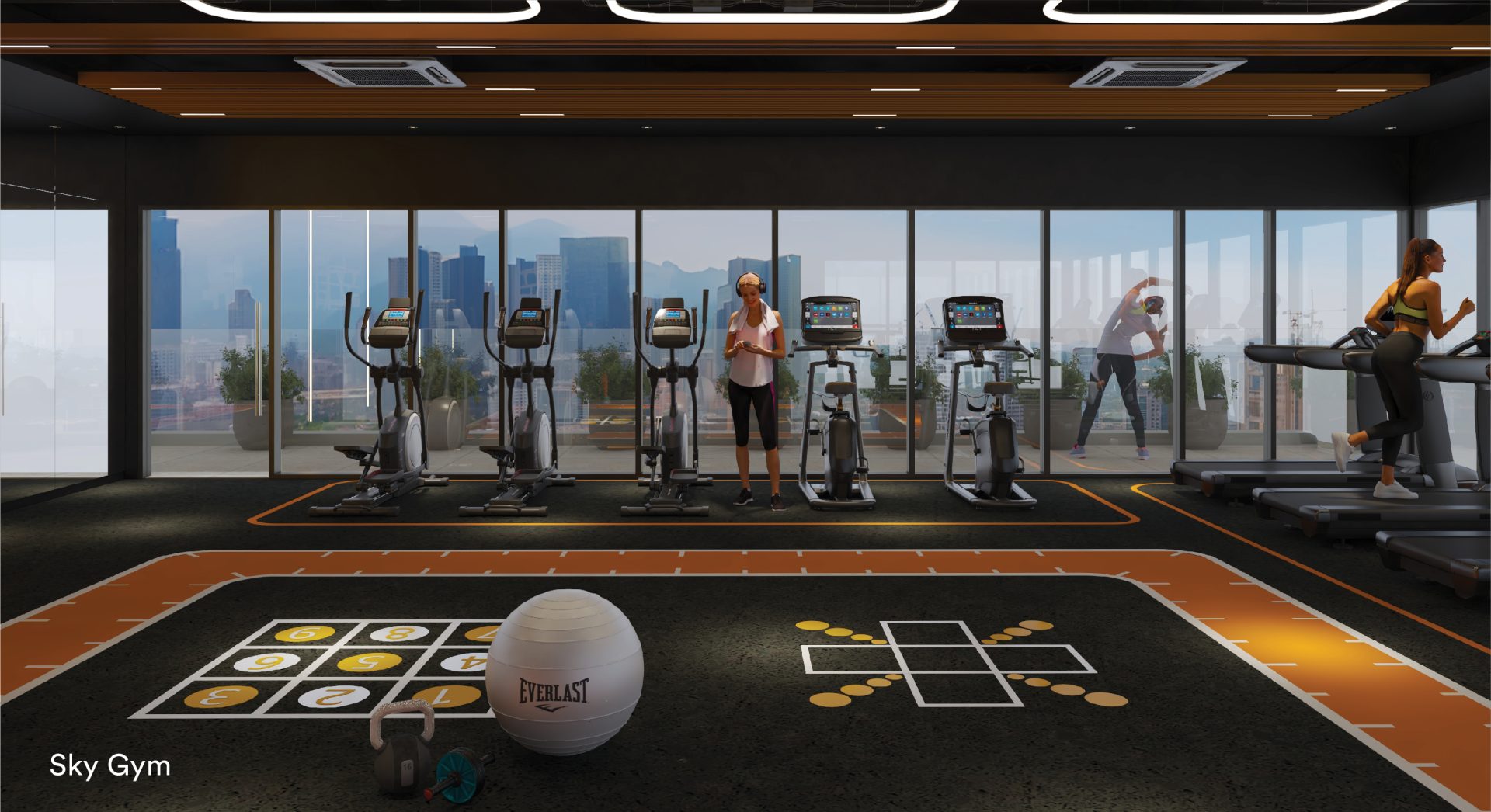 Sky gym with cardio machines and floor-to-ceiling city views at Sena Residences